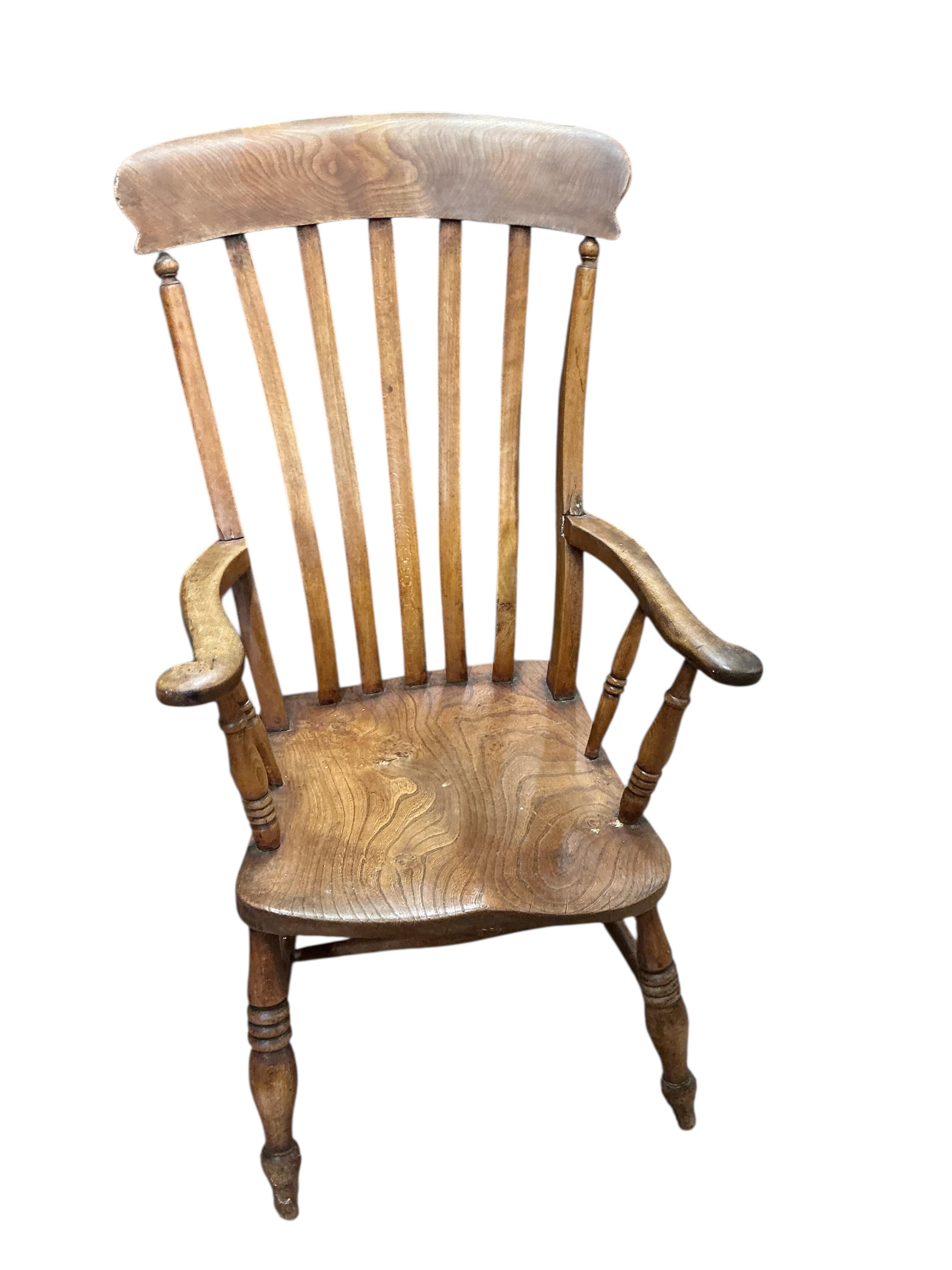 A near pair of Victorian elm and beech Windsor lathe back armchairs